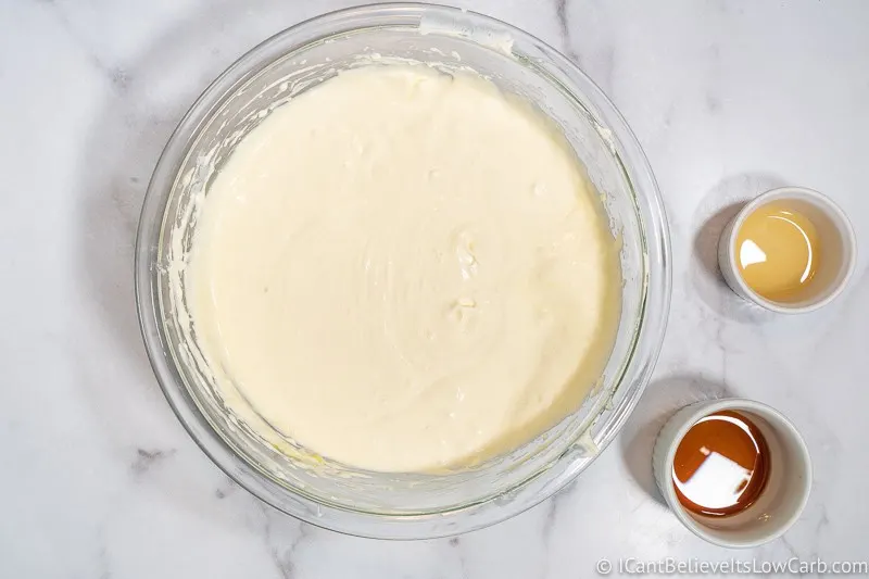 mixing eggs into cheesecake