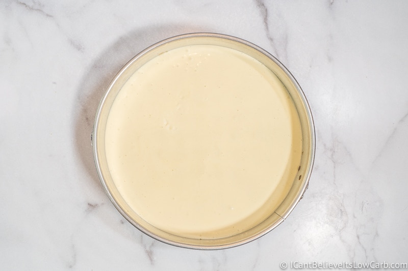 Pouring Sugar Free Cheesecake filling onto the crust