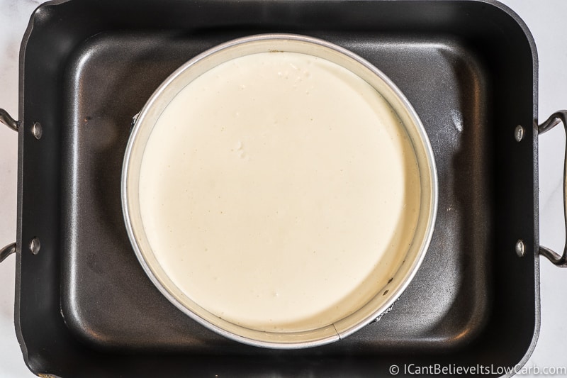 Placing Keto Cheesecake into water bath pan