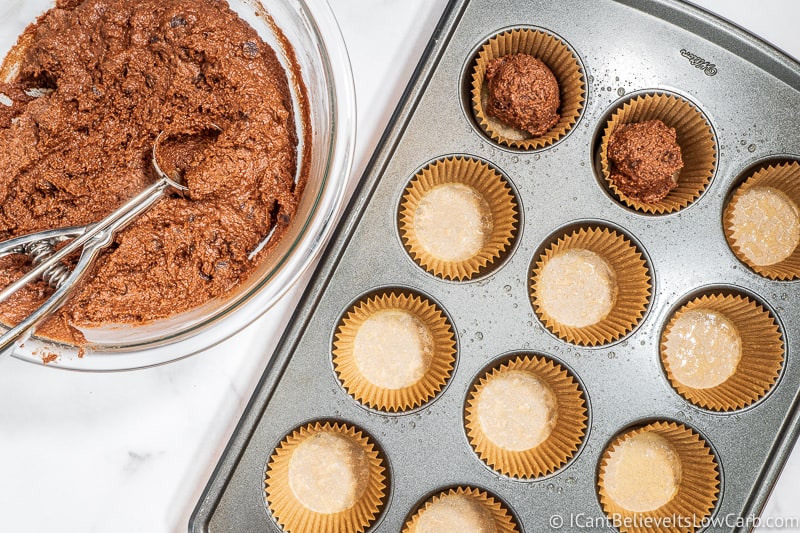 Scooping Keto Chocolate Muffin batter into muffin liners