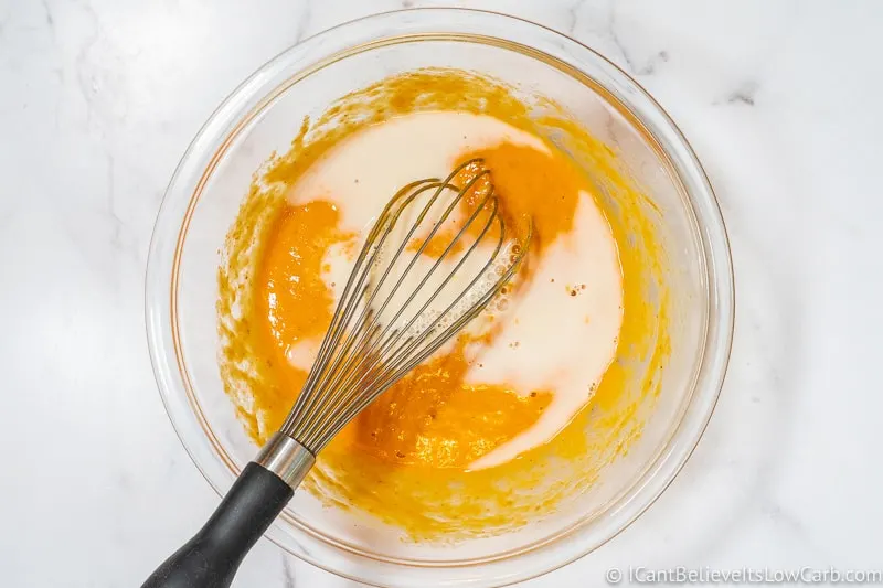 adding almond milk to eggs and pumpkin puree