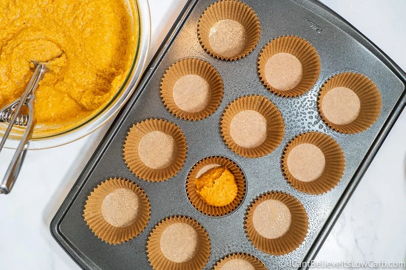 filling Muffin liners with low carb pumpkin muffin mixture