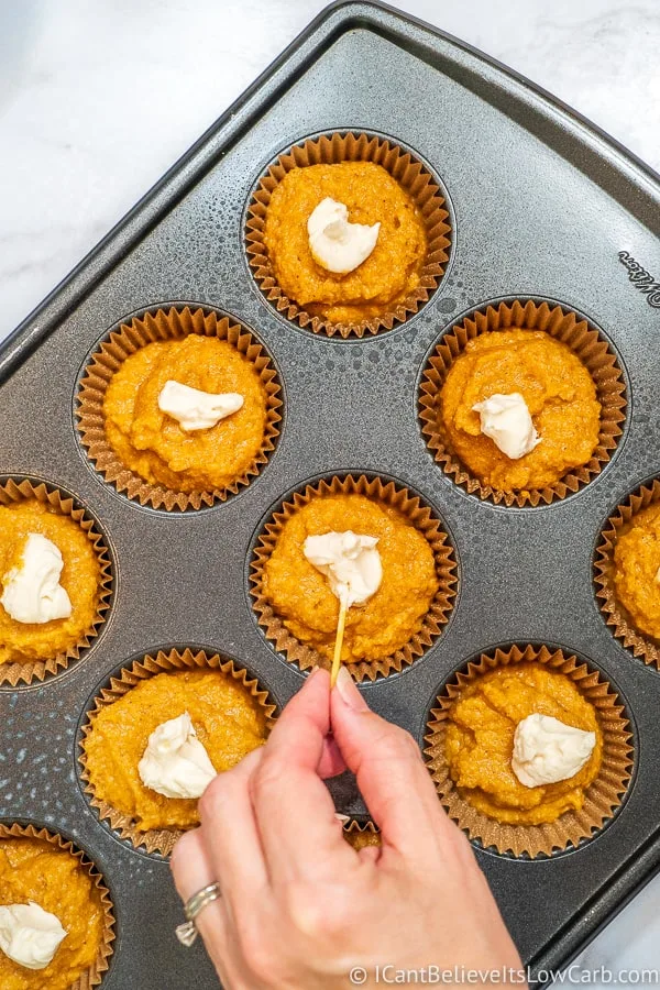 swirling sugar free frosting in pumpkin mixture