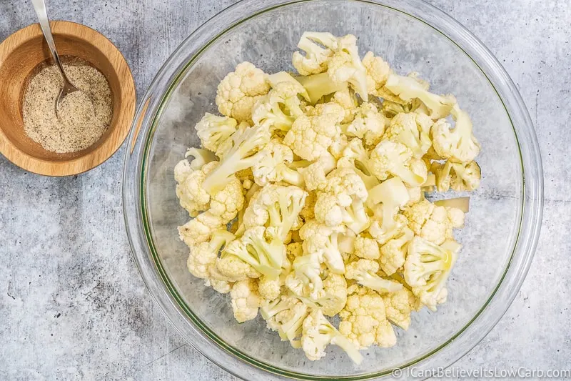 Pouring Olive Oil over Cauliflower florets