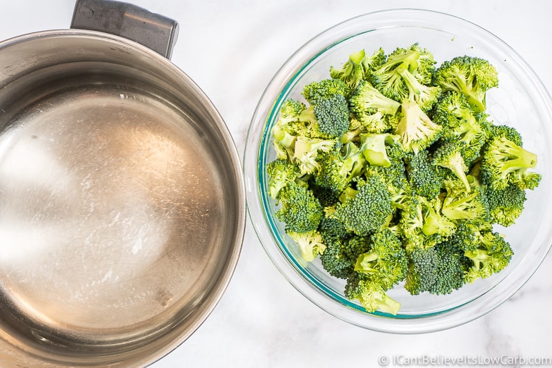 Broccoli in a bowl and empty pot of water
