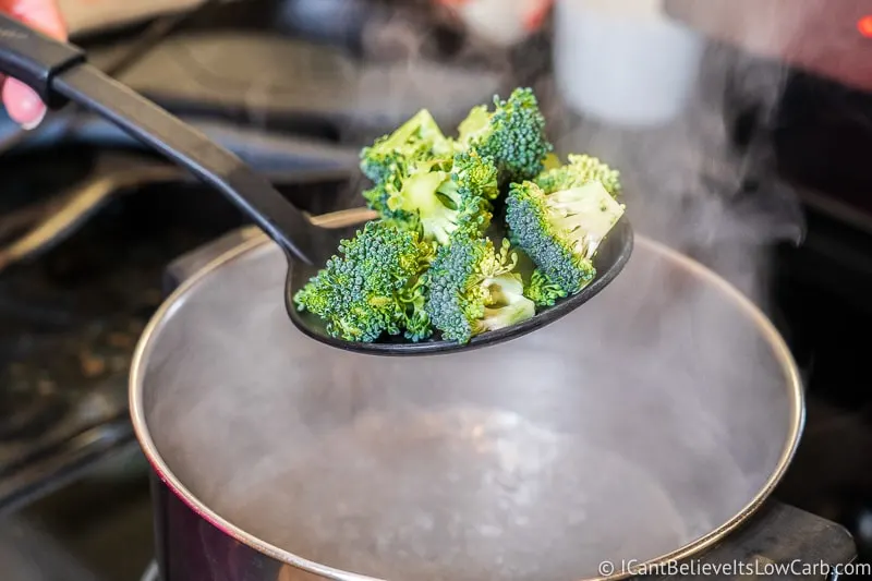 Lowering Broccoli into boiling water