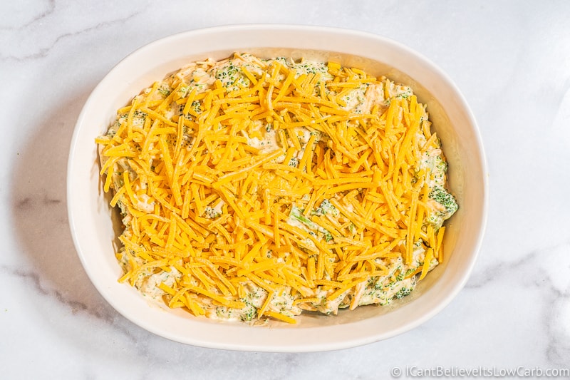 Keto Broccoli Casserole topped with cheese before baking