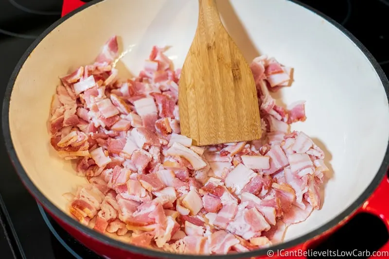 Raw bacon pieces in pan for frying