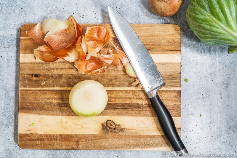 Cutting an onion for Fried Cabbage