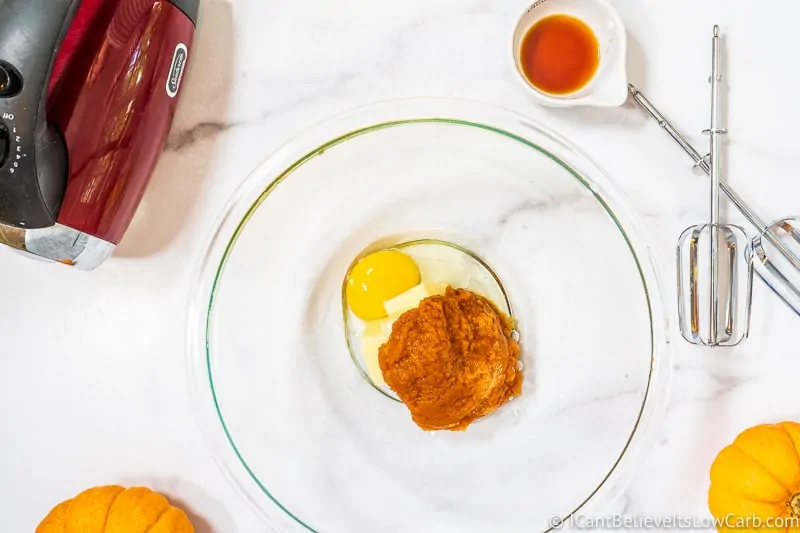 adding egg to bowl for Pumpkin Cookies