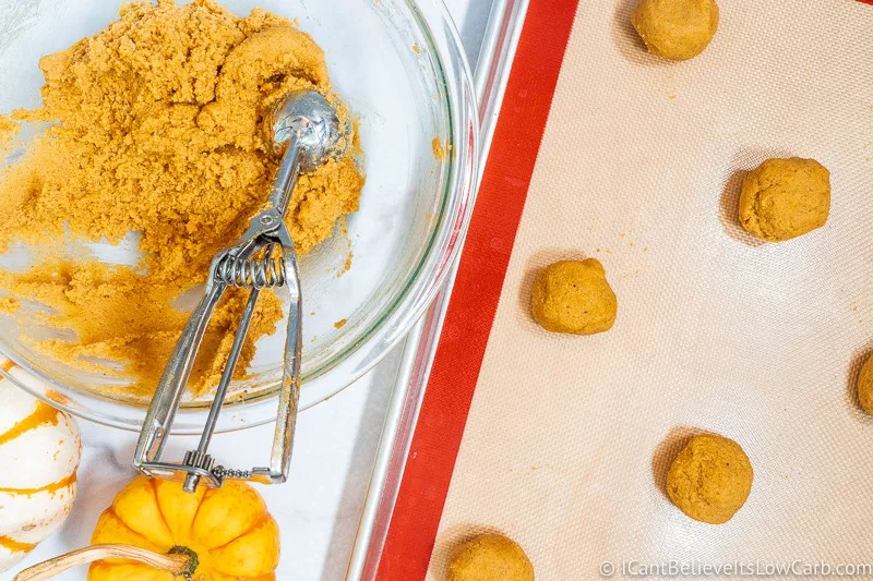 Scooping Keto Pumpkin Cookies on baking tray