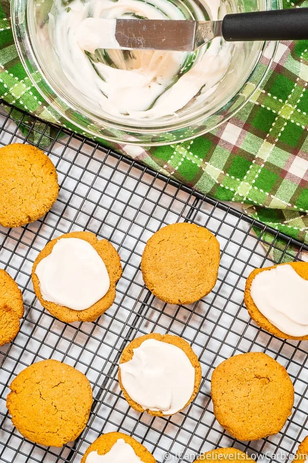 Spreading sugar free icing on Keto Pumpkin Cookies