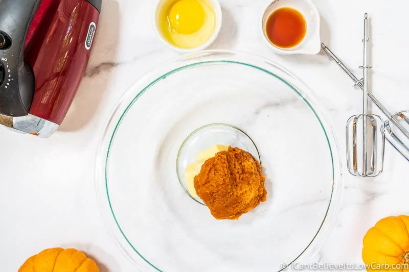 adding pumpkin puree to bowl for Pumpkin Cookies