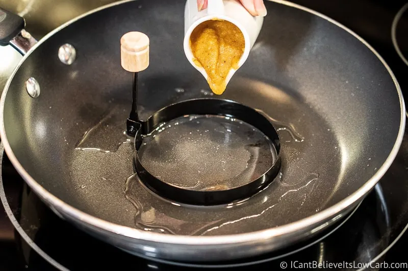 pouring pumpkin pancake mix into pancake ring
