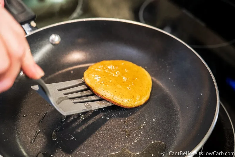 Flipping Keto Pumpkin Pancakes in pan