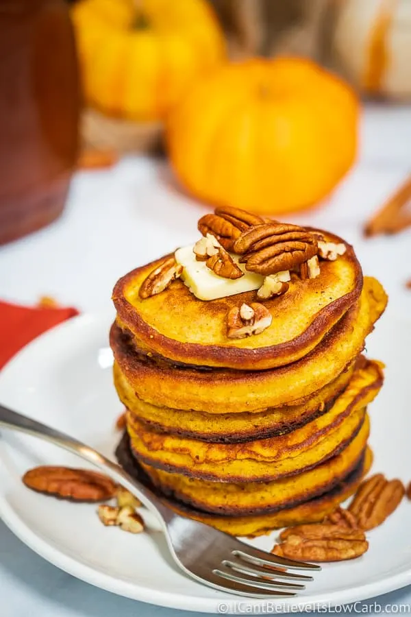 Coconut Flour Pumpkin Pancakes on plate with pecans on top