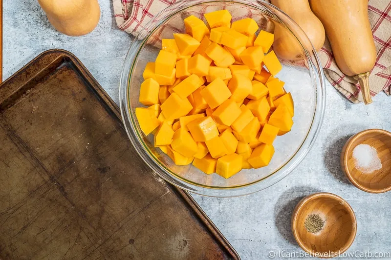 putting cubed Butternut Squash on baking tray