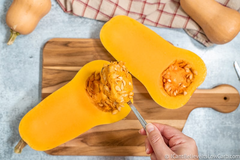 scooping seeds out of Butternut Squash