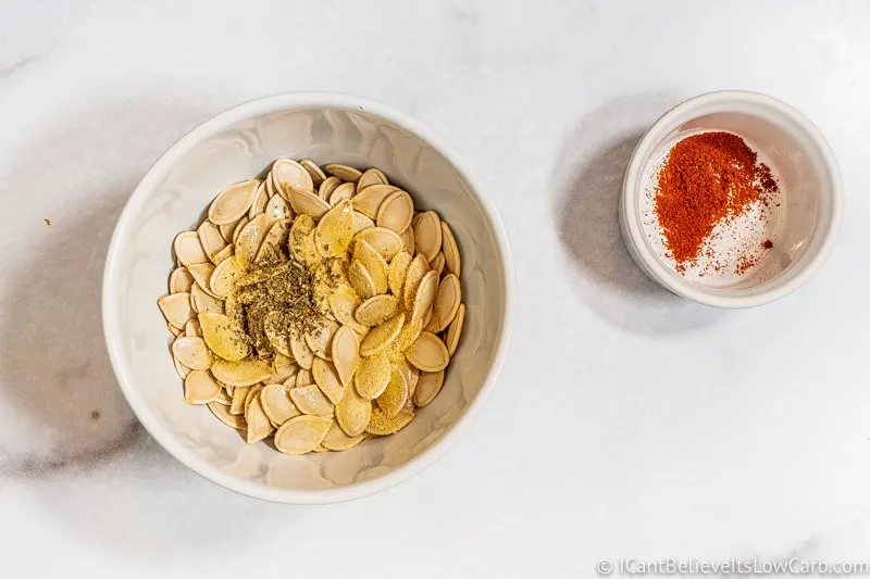 adding seasonings to Pumpkin Seeds