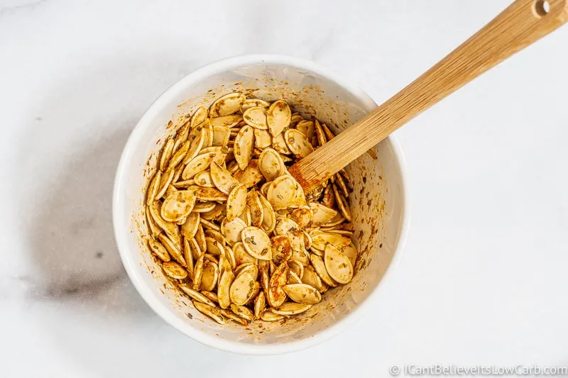 mixing seasonings on Pumpkin Seeds