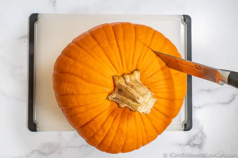 Cutting into the top of a Pumpkin