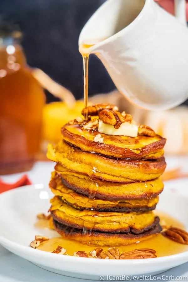 Pouring Keto Maple Syrup on pancakes