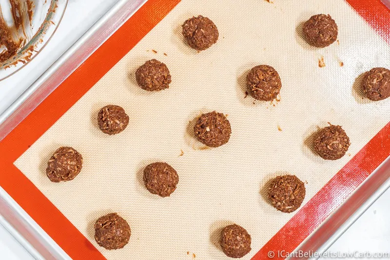 Rolling Keto No Bake Cookies balls on tray