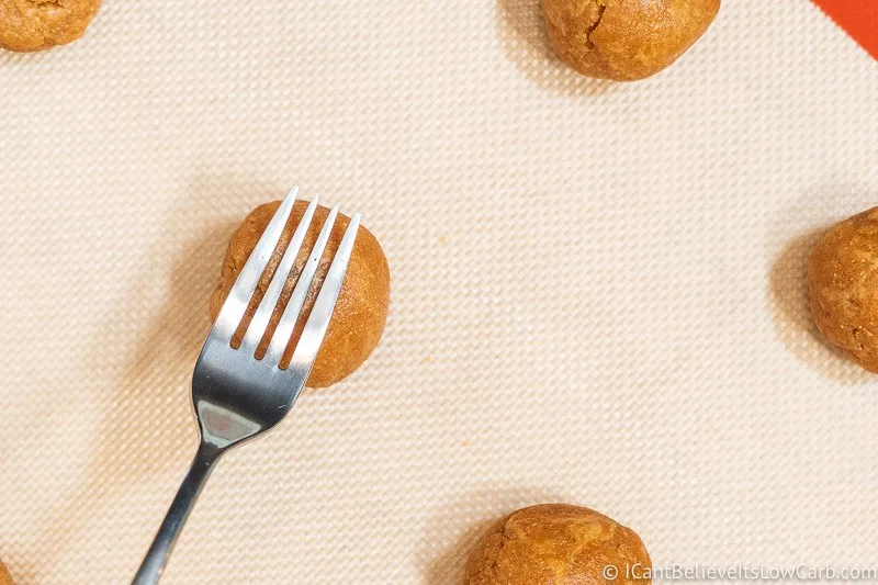 Pressing Keto Peanut Butter Cookies with a fork