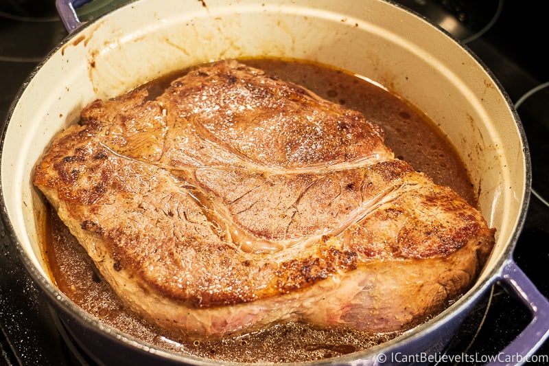 Keto Pot Roast cooking on the stove in a Dutch oven