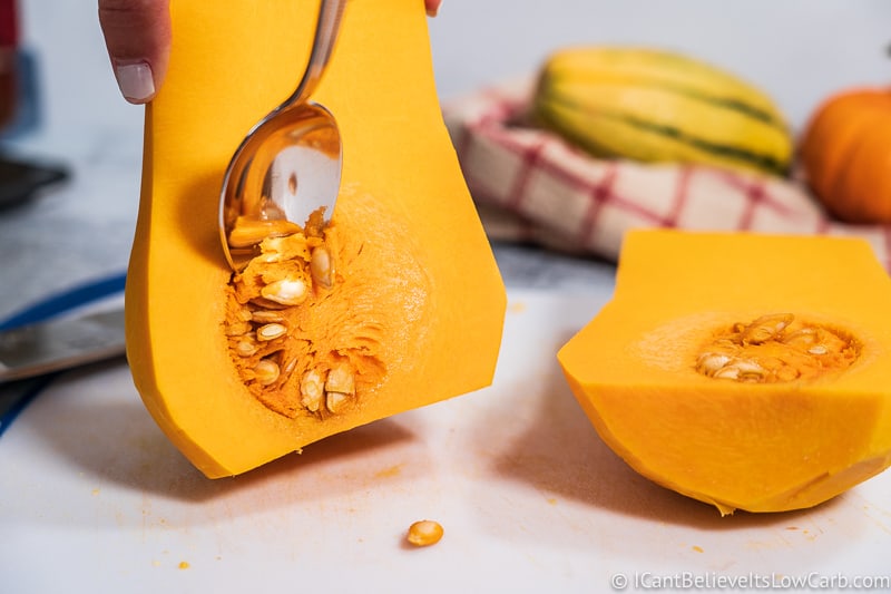 Scooping out seeds from Butternut Squash