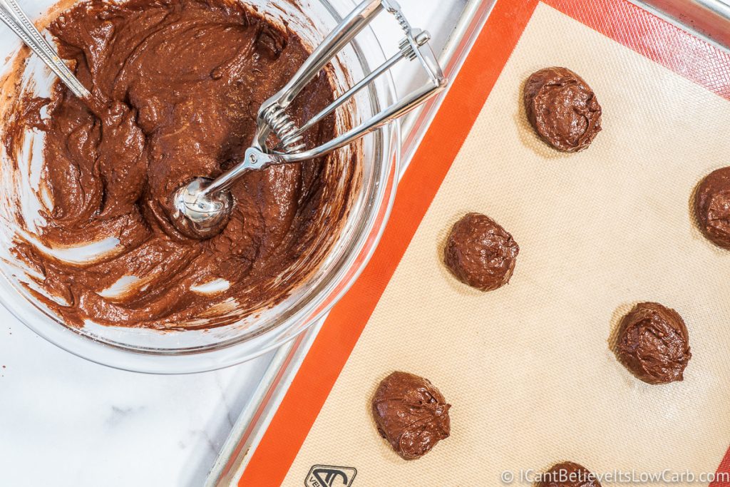 Scooping out Keto Chocolate Cookies on a tray