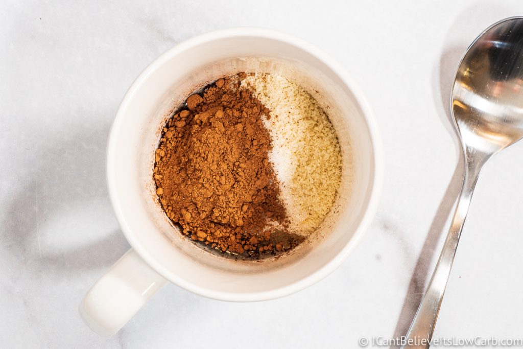 adding unsweetened cocoa to mug