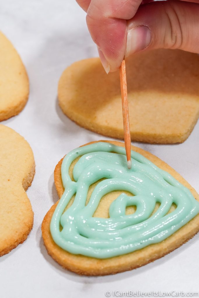 Spreading royal icing on Low Carb Sugar Cookies