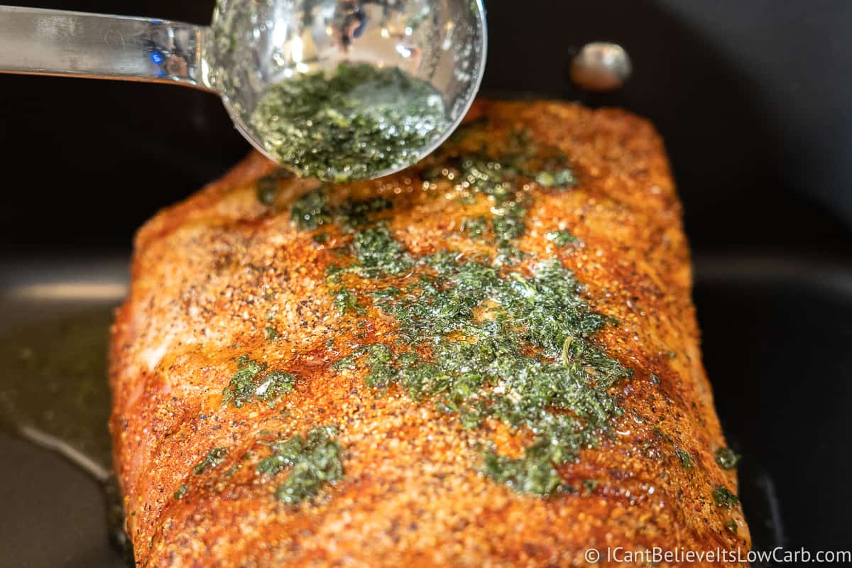 Putting butter sauce on Pork Loin Roast