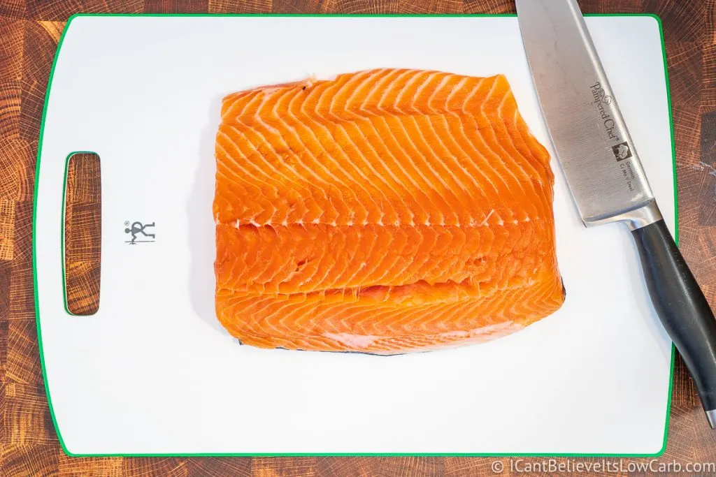 fresh salmon on cutting board with knife