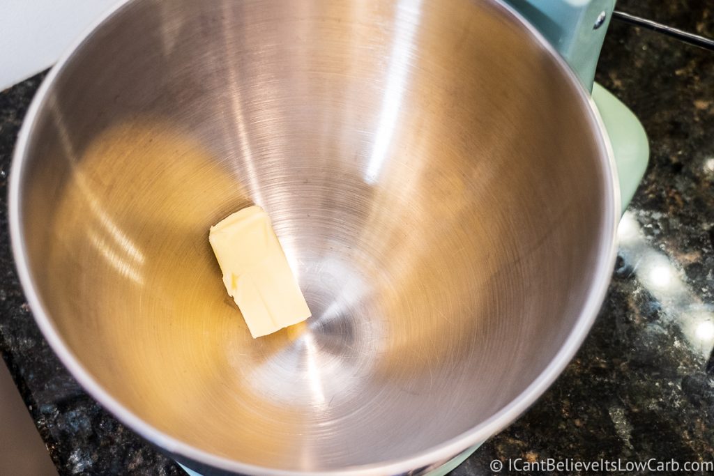 adding butter to mixer bowl