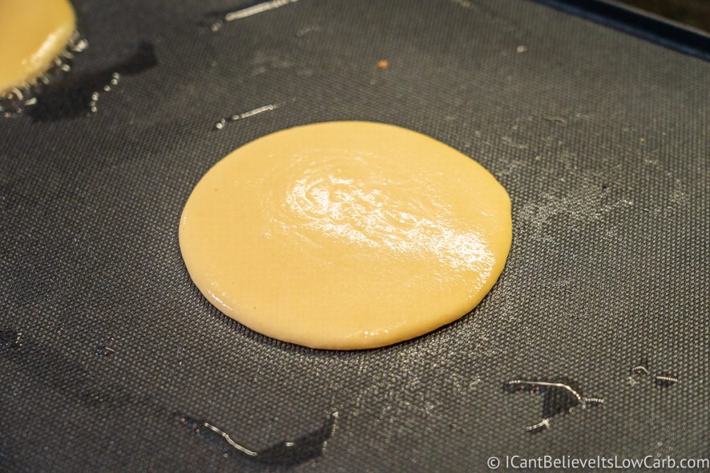Keto Pancakes cooking on the griddle