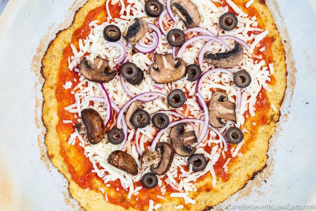 Adding toppings to Cauliflower Pizza Crust