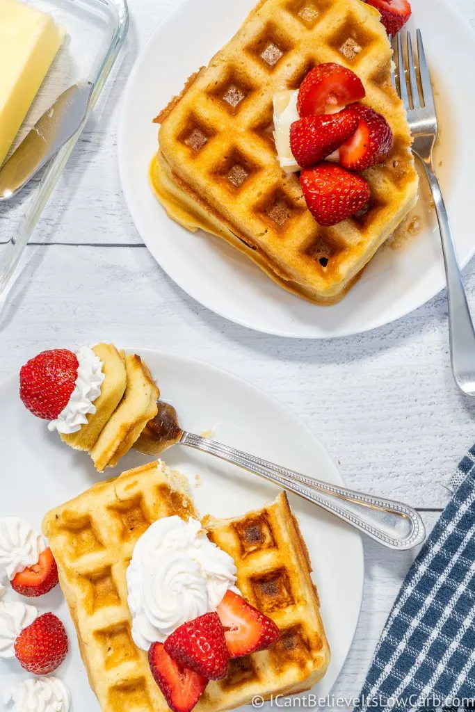 Two plates of Keto Waffles with strawberries on top