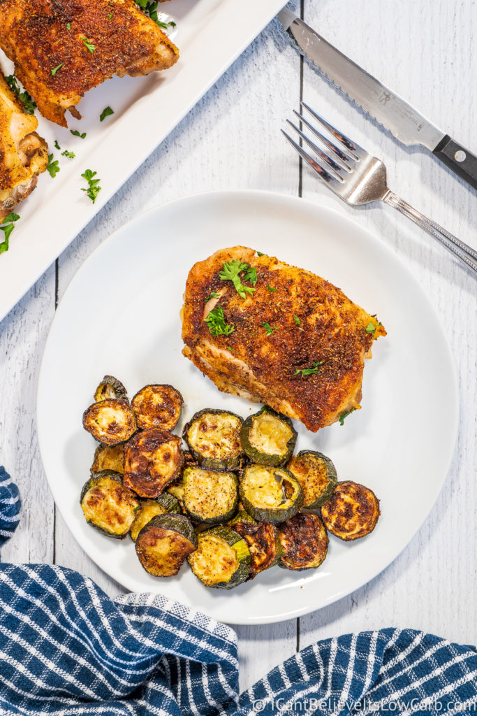 Baked Chicken Thigh on a plate with zucchini