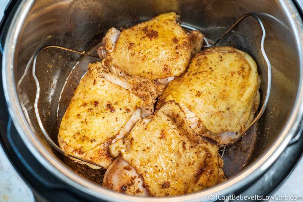 placing Chicken Thighs inside the instant pot on a trivet