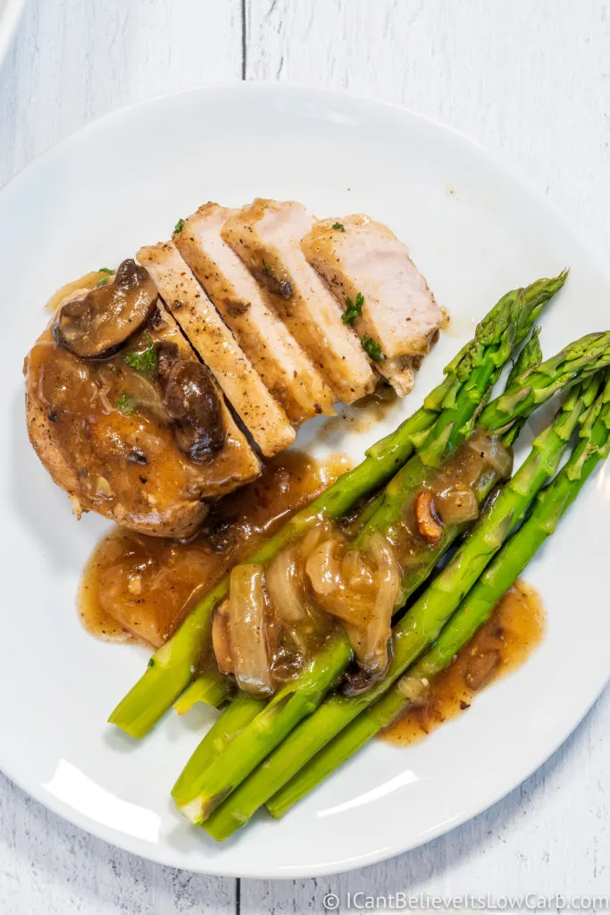 Instant Pot Pork Chops with asparagus on a white plate
