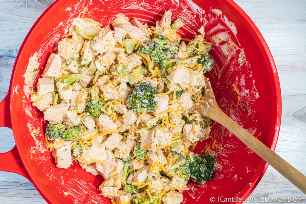 Mixing Low Carb Chicken Casserole ingredients in a bowl