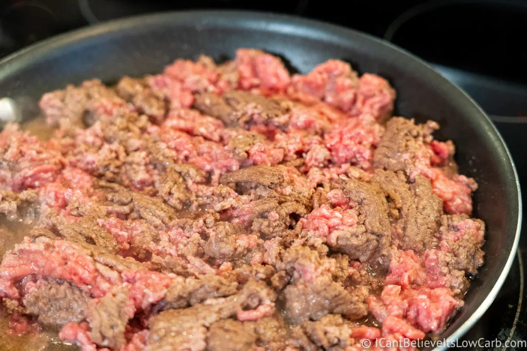 Frying ground beef in a pan on the stove