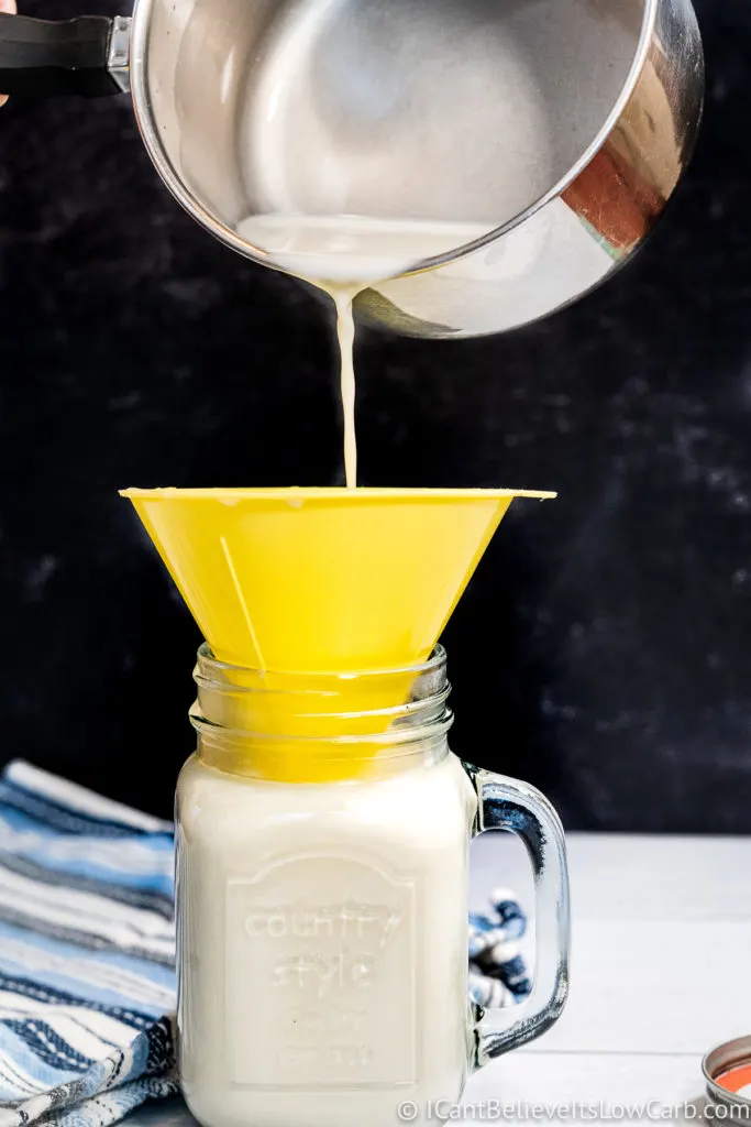 pouring low carb creamer into a jar