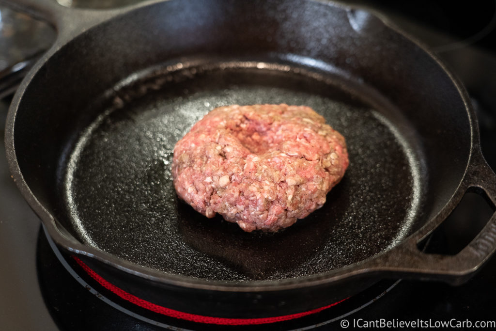 Cooking a Hamburger in a cast iron pan on the stove