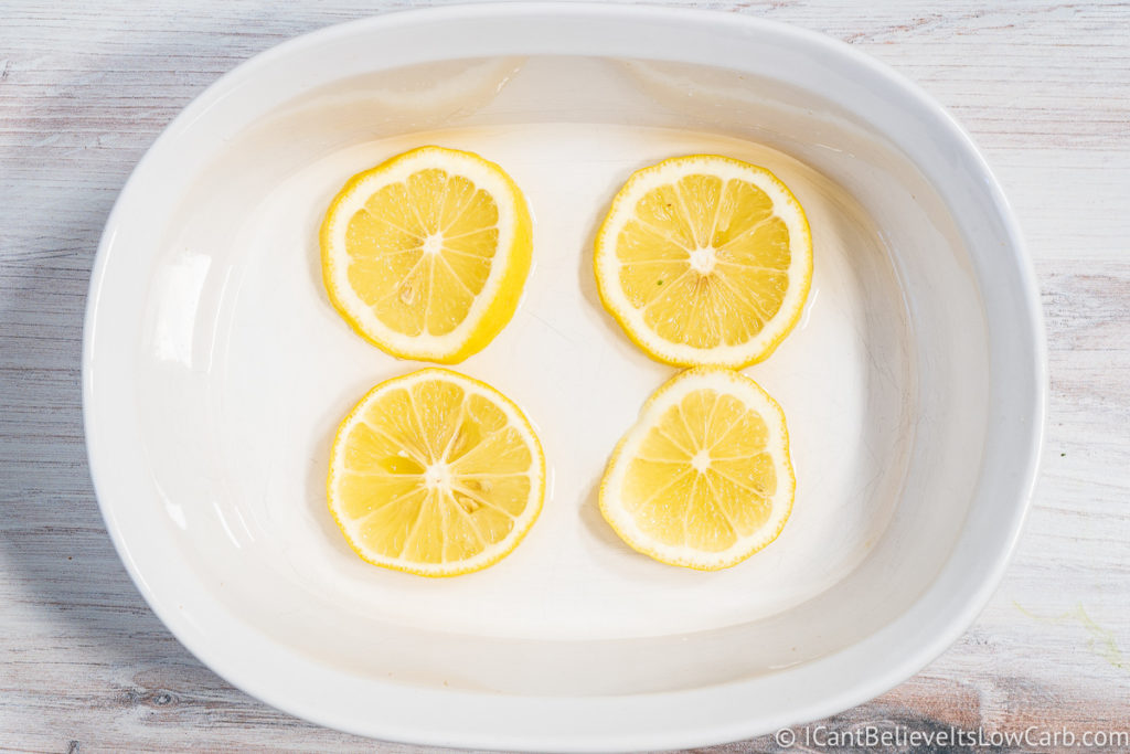 white baking dish with lemon slices