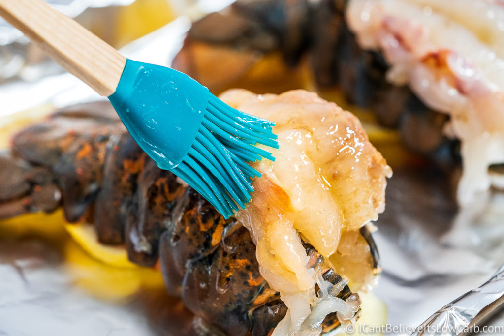 Brushing raw Lobster Tails with butter