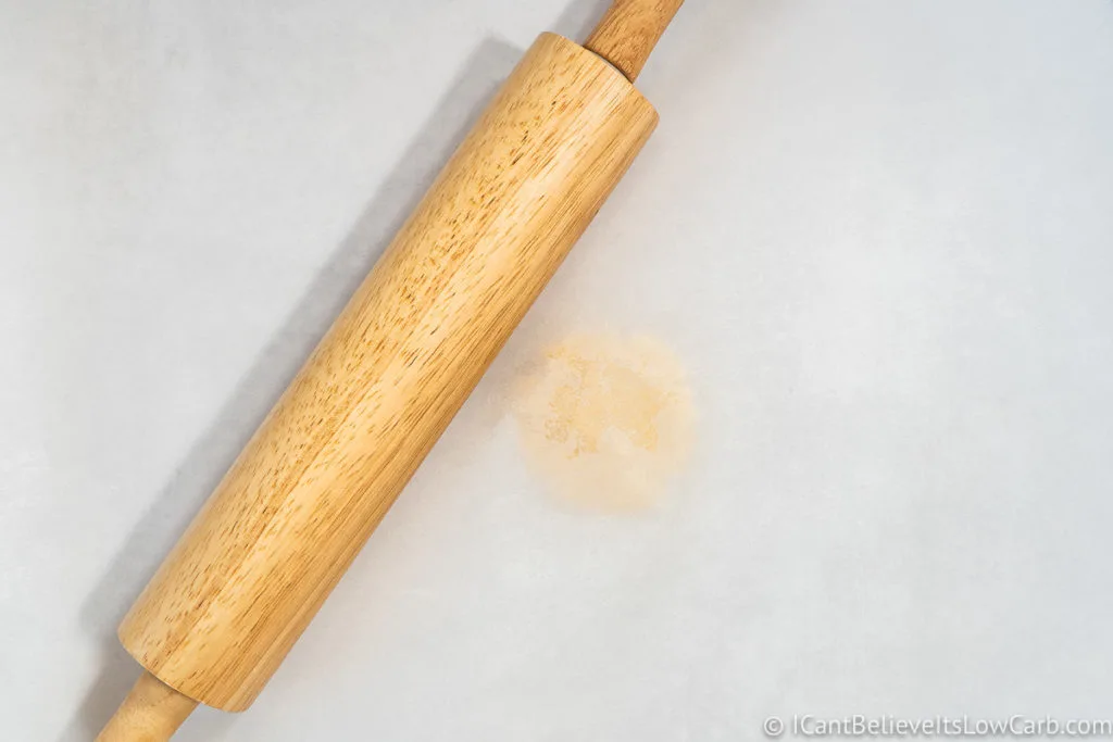 Low Carb Tortilla dough in between parchment paper