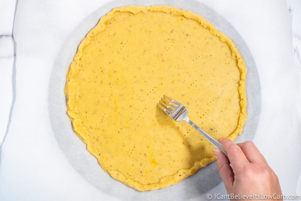 Poking Almond Flour Pizza Crust with a fork